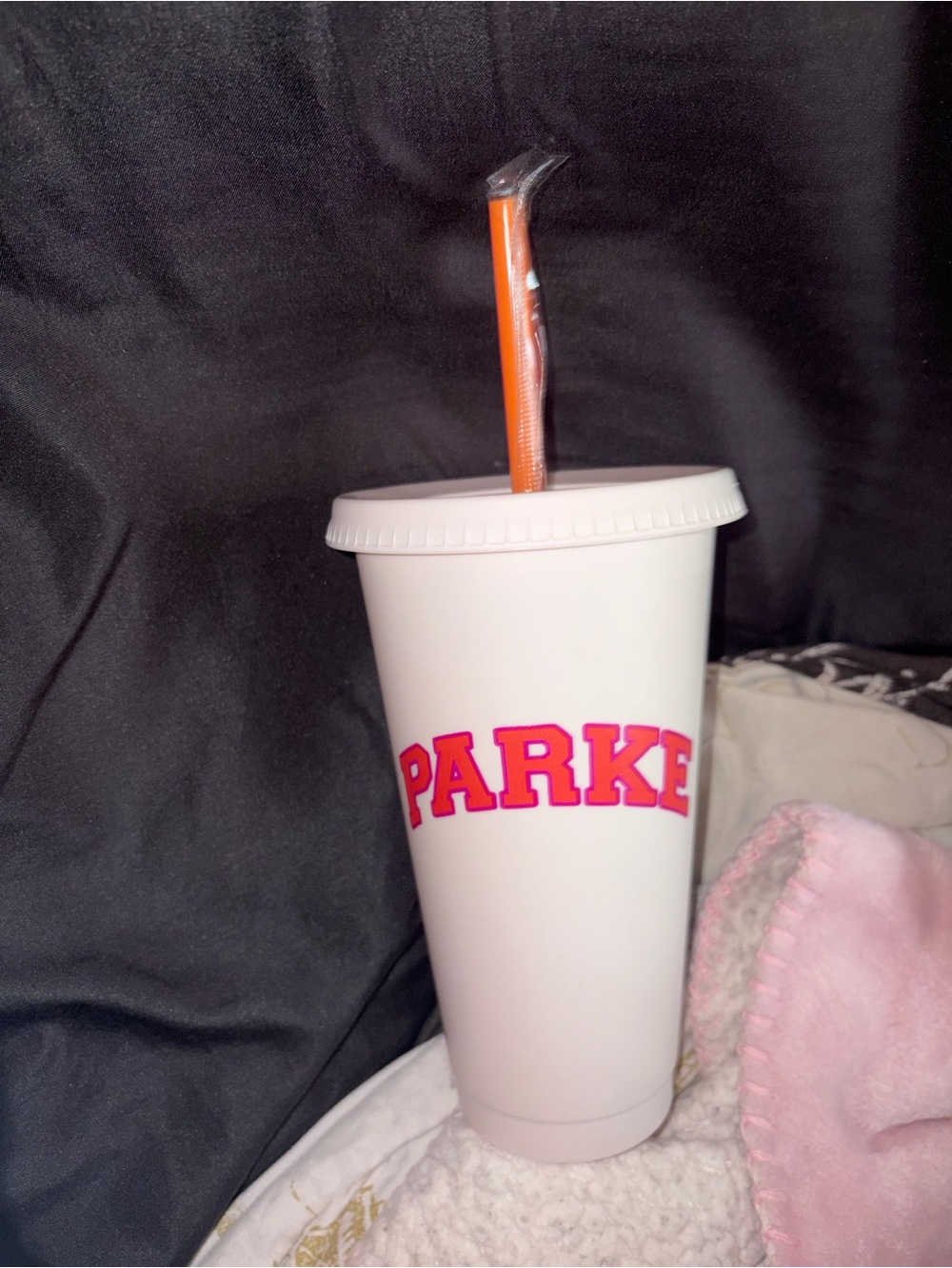 Parker Branded White Cup with Pink Lettering and Orange Straw